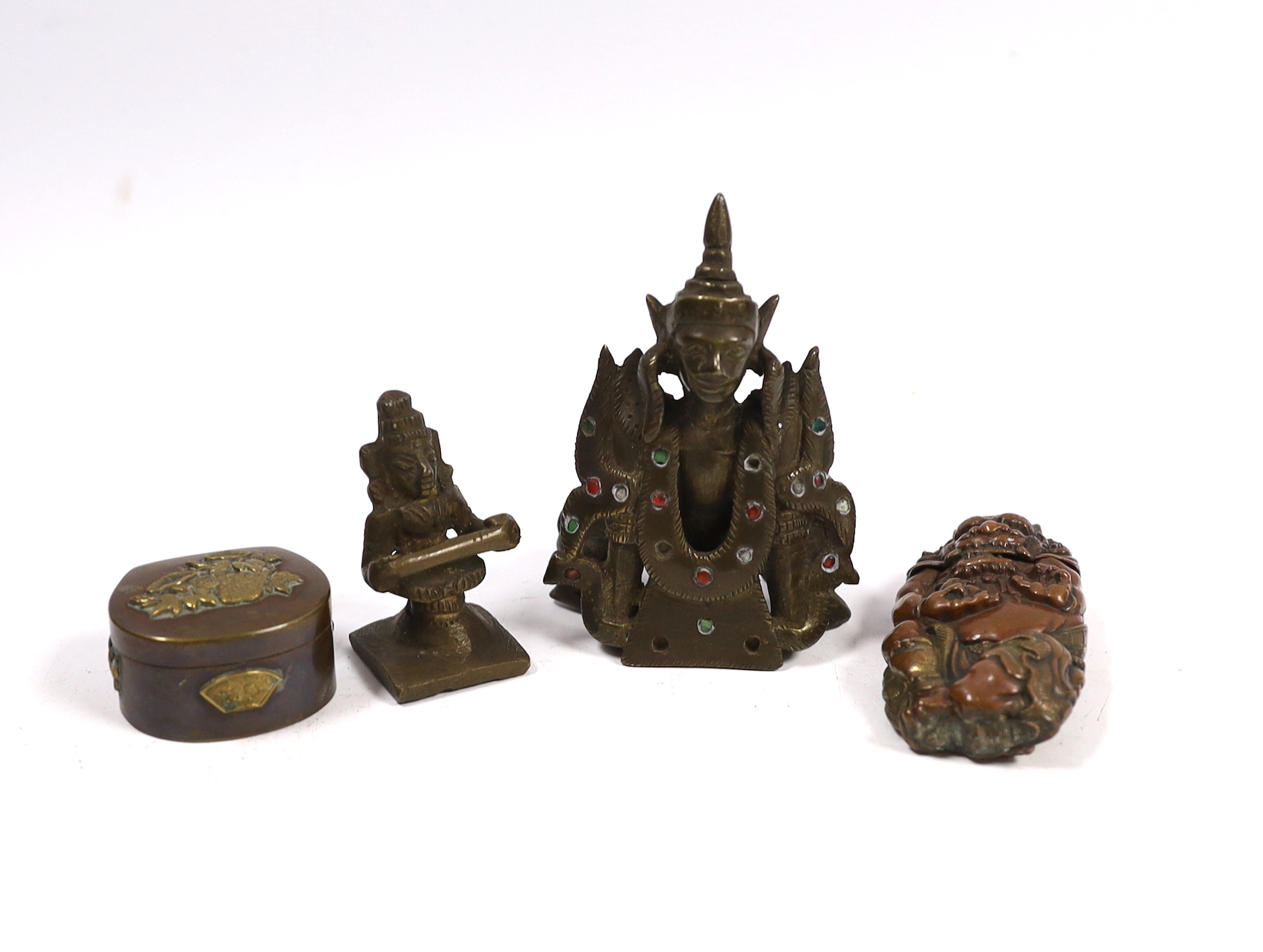 A Japanese mixed metal Vesta case modelled as an oni, a similar box, a Thai bronze figure and an Indian brass figure (4)